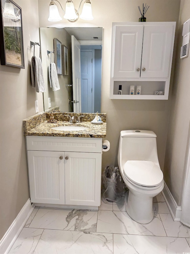 bathroom featuring vanity and toilet