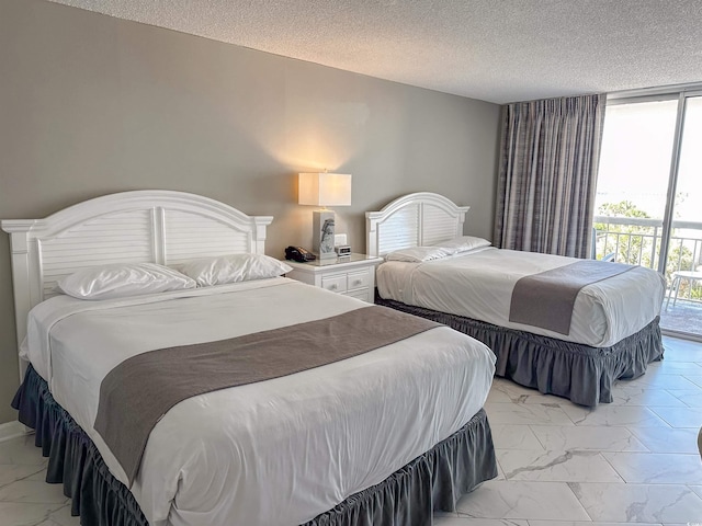 bedroom with access to outside and a textured ceiling