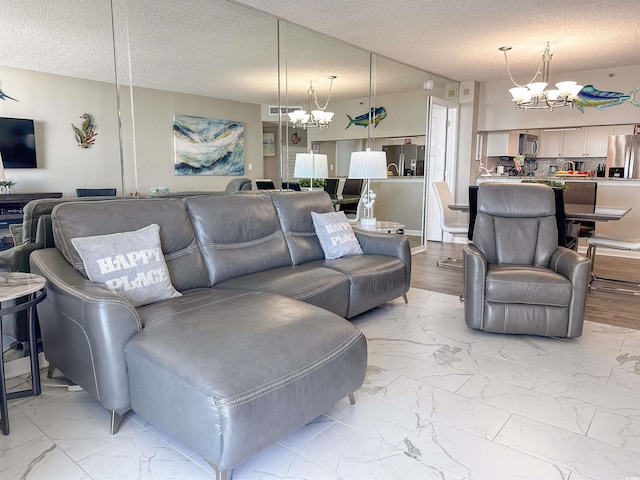 living room with a textured ceiling and an inviting chandelier