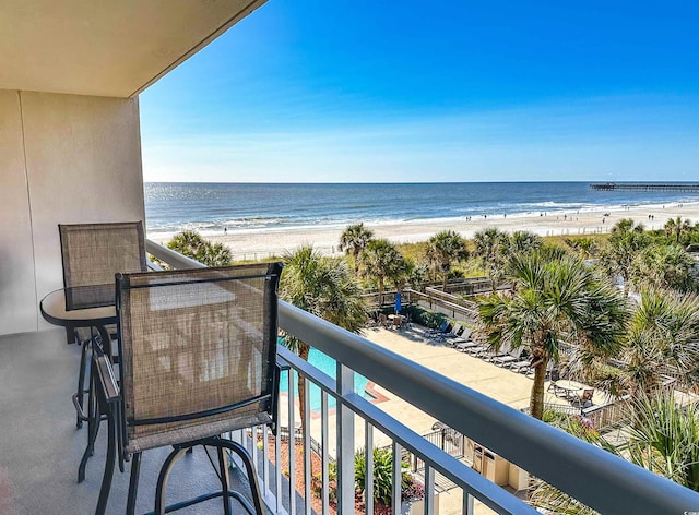 balcony with a view of the beach and a water view