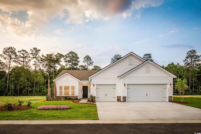 ranch-style house featuring a garage and a front lawn