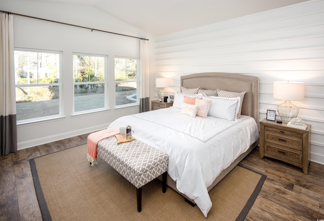 bedroom with lofted ceiling and dark hardwood / wood-style flooring