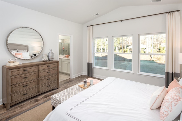 bedroom featuring lofted ceiling, ensuite bathroom, and wood-type flooring