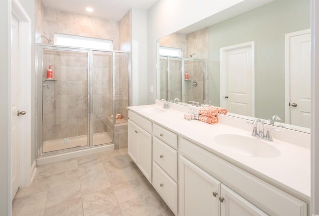 bathroom with vanity and a shower with shower door