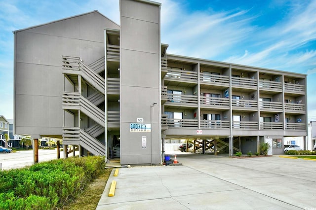 view of building exterior featuring covered parking