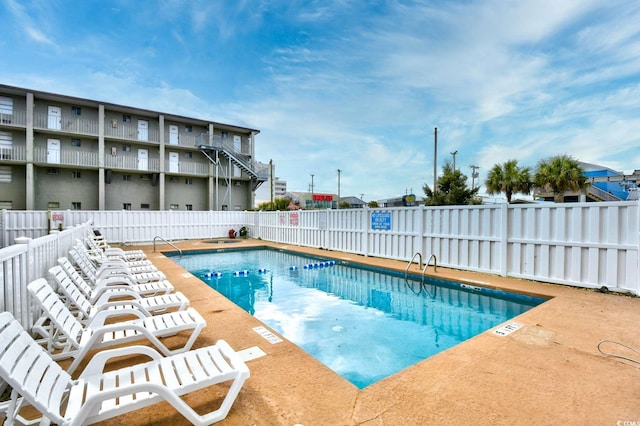 pool with fence and a patio area