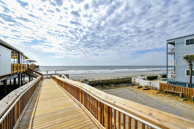 view of community featuring a beach view and a water view