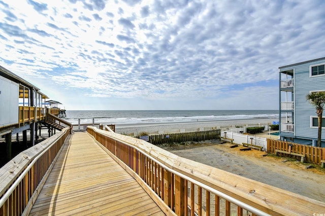 surrounding community featuring a beach view and a water view