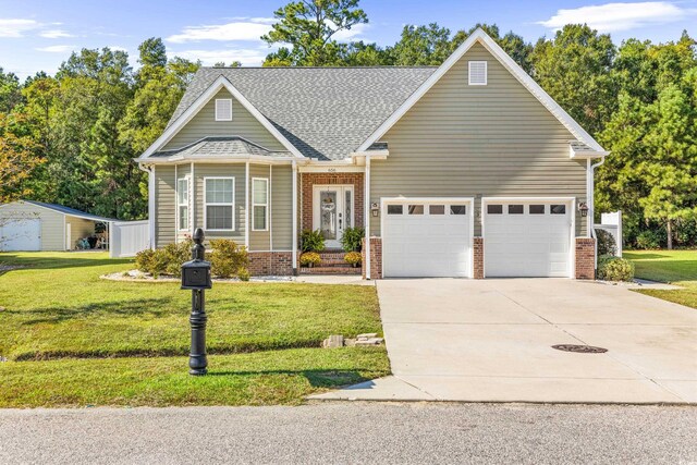 view of front of home with a garage and a front lawn