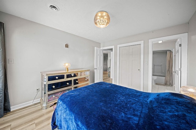 bedroom with connected bathroom, a closet, and wood-type flooring