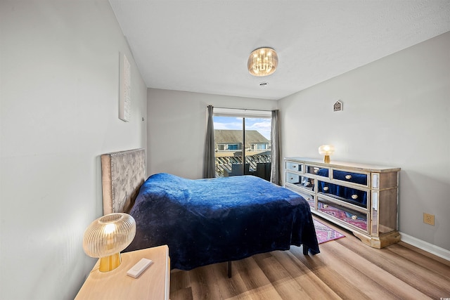 bedroom with hardwood / wood-style floors