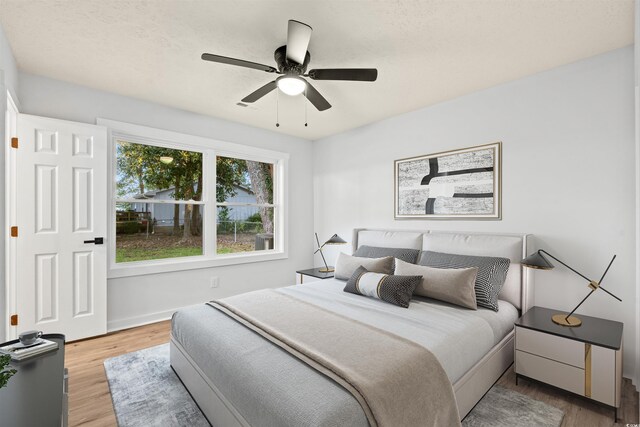 bedroom featuring hardwood / wood-style flooring and ceiling fan