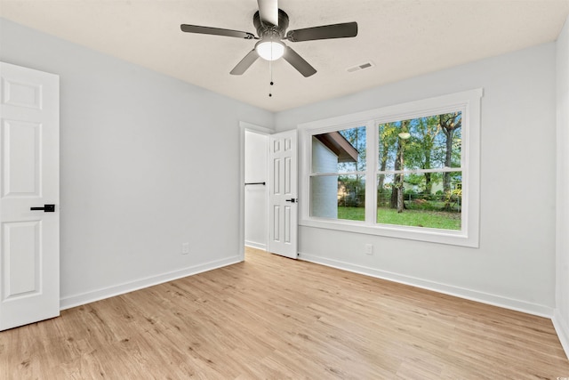 spare room with light hardwood / wood-style flooring and ceiling fan