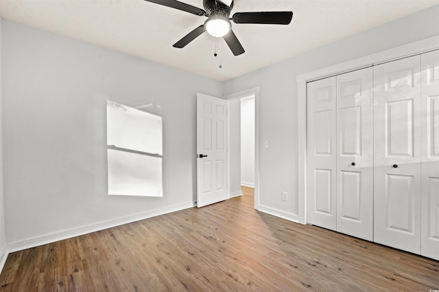 unfurnished bedroom featuring a closet, light hardwood / wood-style flooring, and ceiling fan