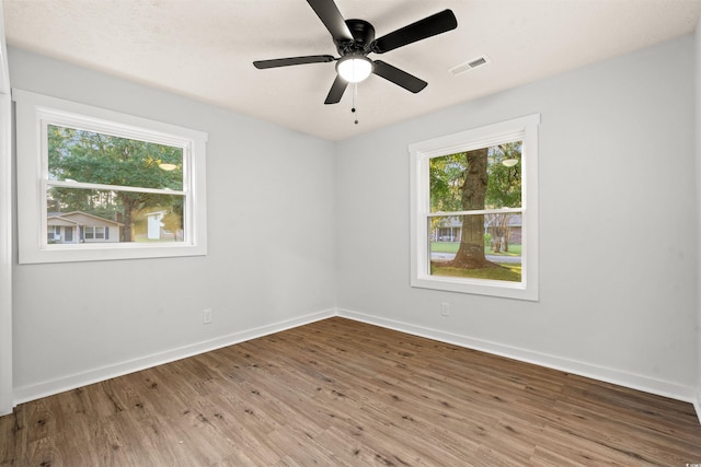 empty room featuring hardwood / wood-style flooring and ceiling fan