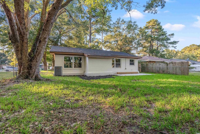 back of house featuring a yard and a patio area