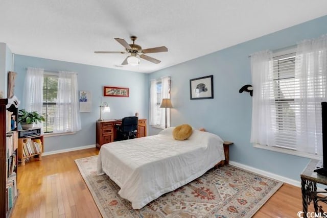 bedroom with ceiling fan and light wood-type flooring