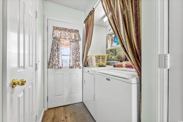 washroom with separate washer and dryer and hardwood / wood-style floors