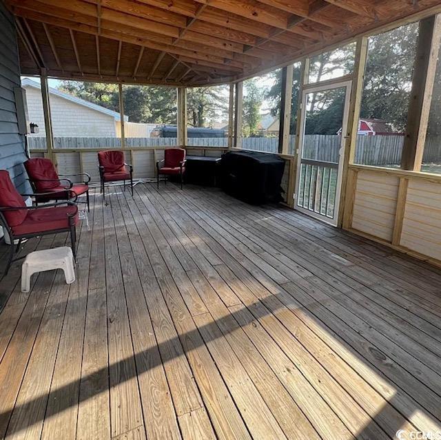 unfurnished sunroom with vaulted ceiling