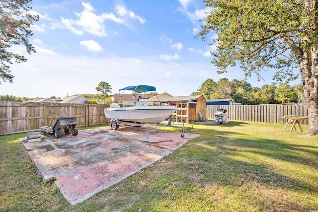 view of yard featuring a storage unit and a patio area