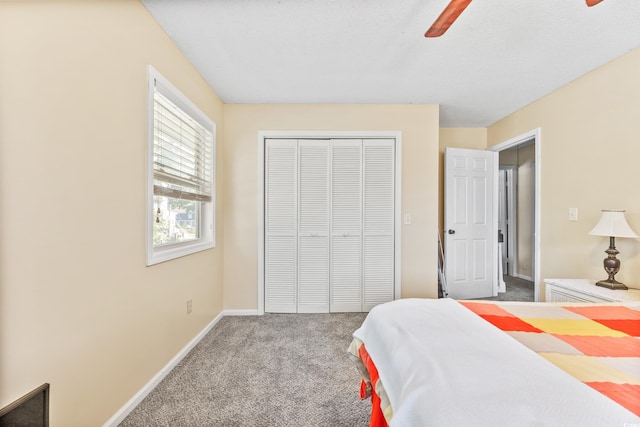 carpeted bedroom with a closet and ceiling fan