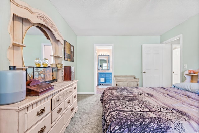 bedroom featuring light carpet and a textured ceiling