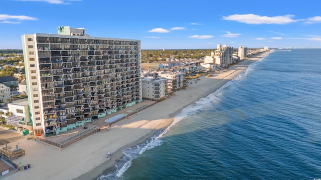 bird's eye view with a water view and a beach view