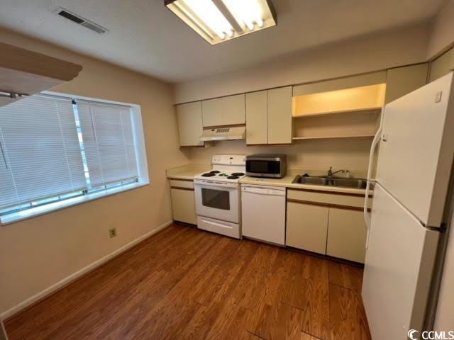 kitchen featuring white cabinets, white appliances, light hardwood / wood-style flooring, and sink