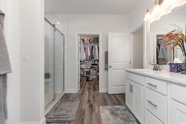 bathroom featuring vanity, hardwood / wood-style flooring, and walk in shower