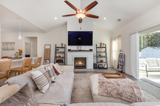 living room with high vaulted ceiling, light wood-type flooring, and ceiling fan