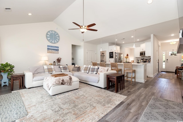 living room featuring ceiling fan, high vaulted ceiling, and dark hardwood / wood-style flooring