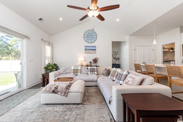 living room featuring lofted ceiling, hardwood / wood-style floors, and ceiling fan