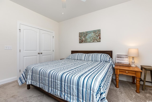 carpeted bedroom with a closet and ceiling fan