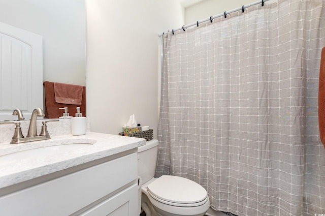 bathroom featuring toilet and vanity