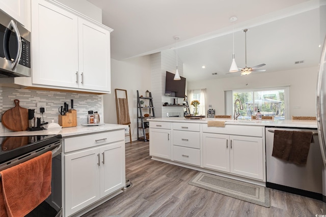 kitchen featuring white cabinets, stainless steel appliances, light hardwood / wood-style floors, and ceiling fan