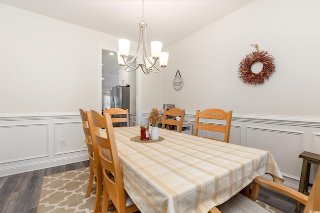 dining room featuring a notable chandelier and dark hardwood / wood-style floors