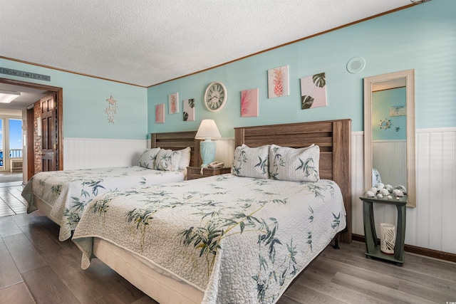 200 76th Ave N Unit 1106, Myrtle Beach, SC 29572 - bedroom with a wainscoted wall, wood finished floors, crown molding, a textured ceiling, and wooden walls