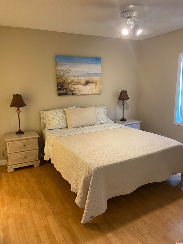 bedroom featuring light wood-type flooring and ceiling fan