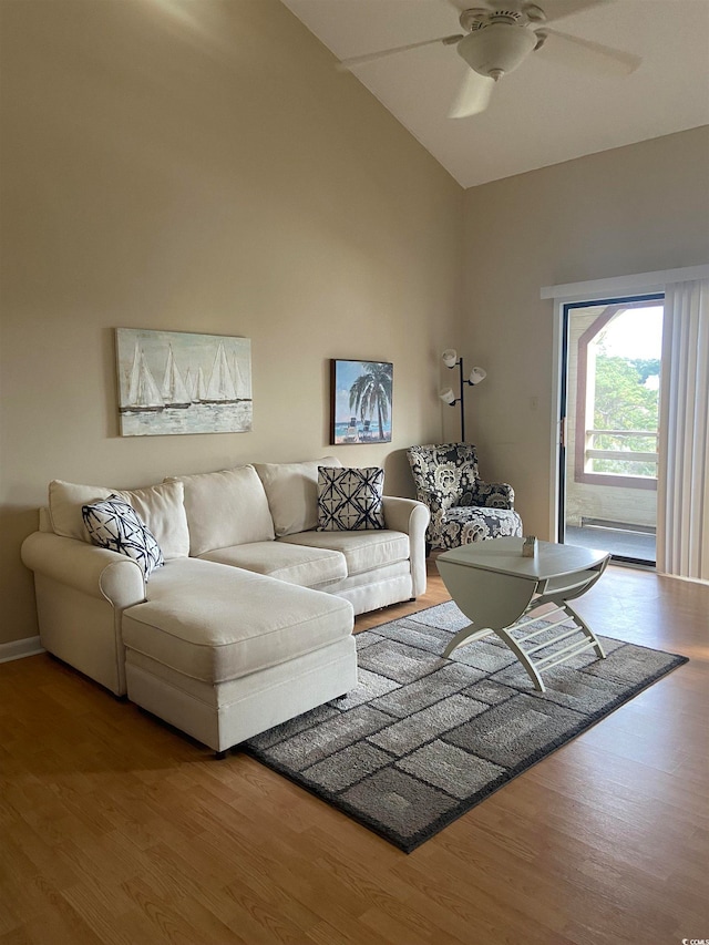 living room featuring wood-type flooring, high vaulted ceiling, and ceiling fan