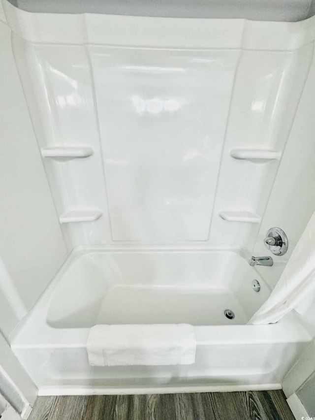 bathroom featuring shower / bath combination with curtain and wood-type flooring