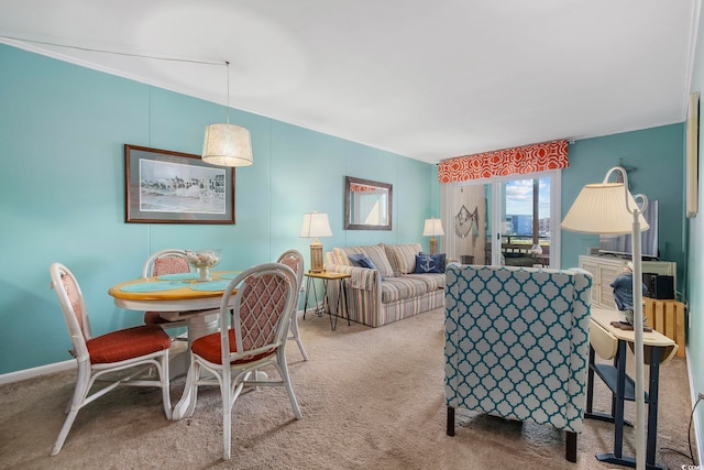 carpeted living room with ornamental molding