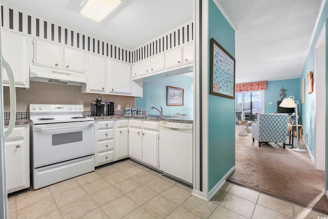 kitchen featuring backsplash, white cabinets, white appliances, sink, and light colored carpet