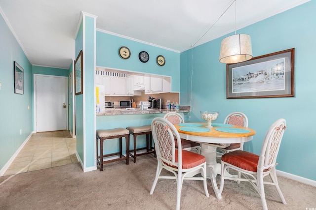 dining room with crown molding and light carpet