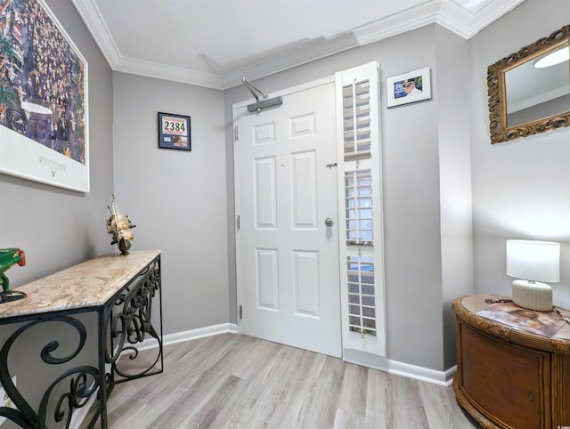 foyer with ornamental molding and light wood-type flooring