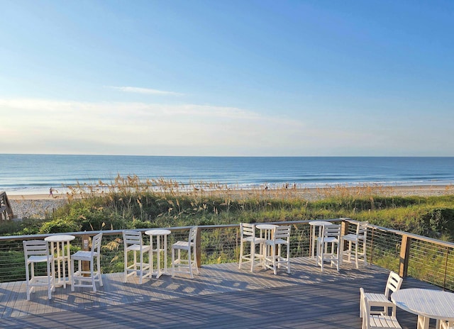 deck with a water view and a beach view