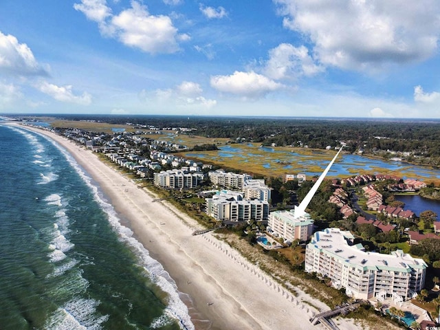 birds eye view of property featuring a water view and a beach view