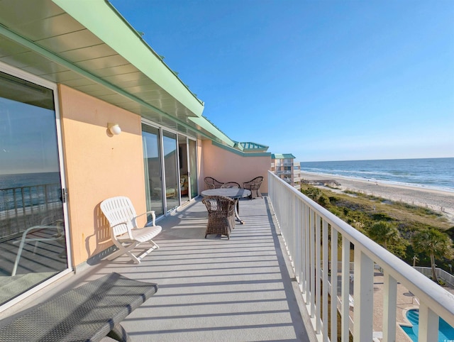 balcony featuring a water view and a view of the beach