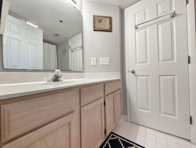 bathroom with tile patterned flooring and vanity