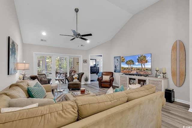 living room with vaulted ceiling, light hardwood / wood-style floors, and ceiling fan