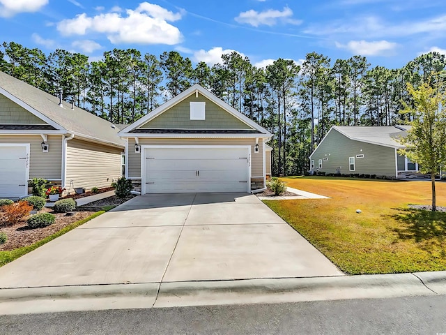 view of front of home featuring a front yard and a garage